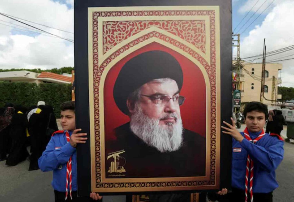 Boys scouts carry a picture of Hezbollah leader Sayyed Hassan Nasrallah