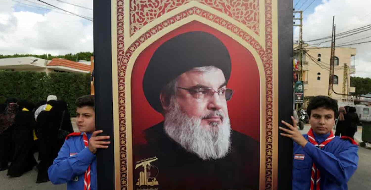 Boys scouts carry a picture of Hezbollah leader Sayyed Hassan Nasrallah