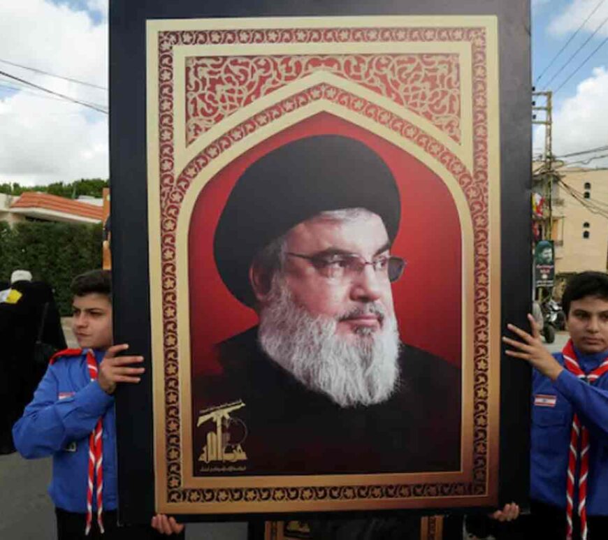 Boys scouts carry a picture of Hezbollah leader Sayyed Hassan Nasrallah