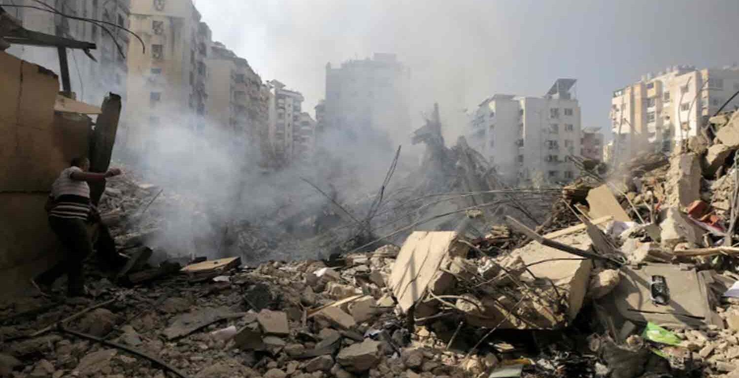 A man walks on the rubble of damaged buildings in the aftermath of Israeli air strikes on Beirut's southern suburbs, Lebanon