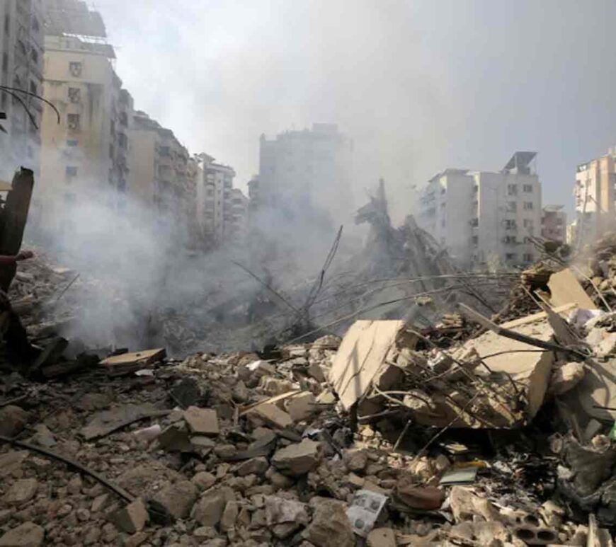 A man walks on the rubble of damaged buildings in the aftermath of Israeli air strikes on Beirut's southern suburbs, Lebanon