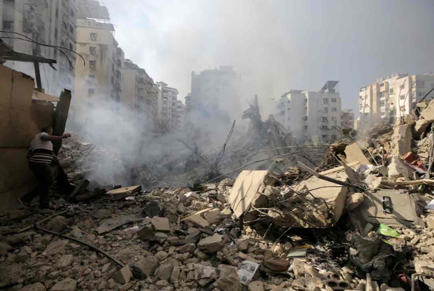 A man walks on the rubble of damaged buildings in the aftermath of Israeli air strikes on Beirut's southern suburbs, Lebanon