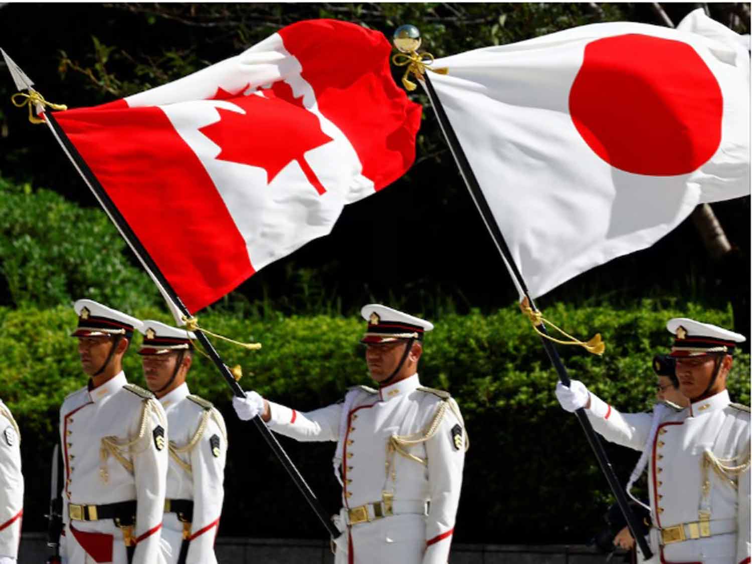 Japanese-honour-guards-hold-the-national-flags-of-Canada-and-Japan-during-a-ceremony