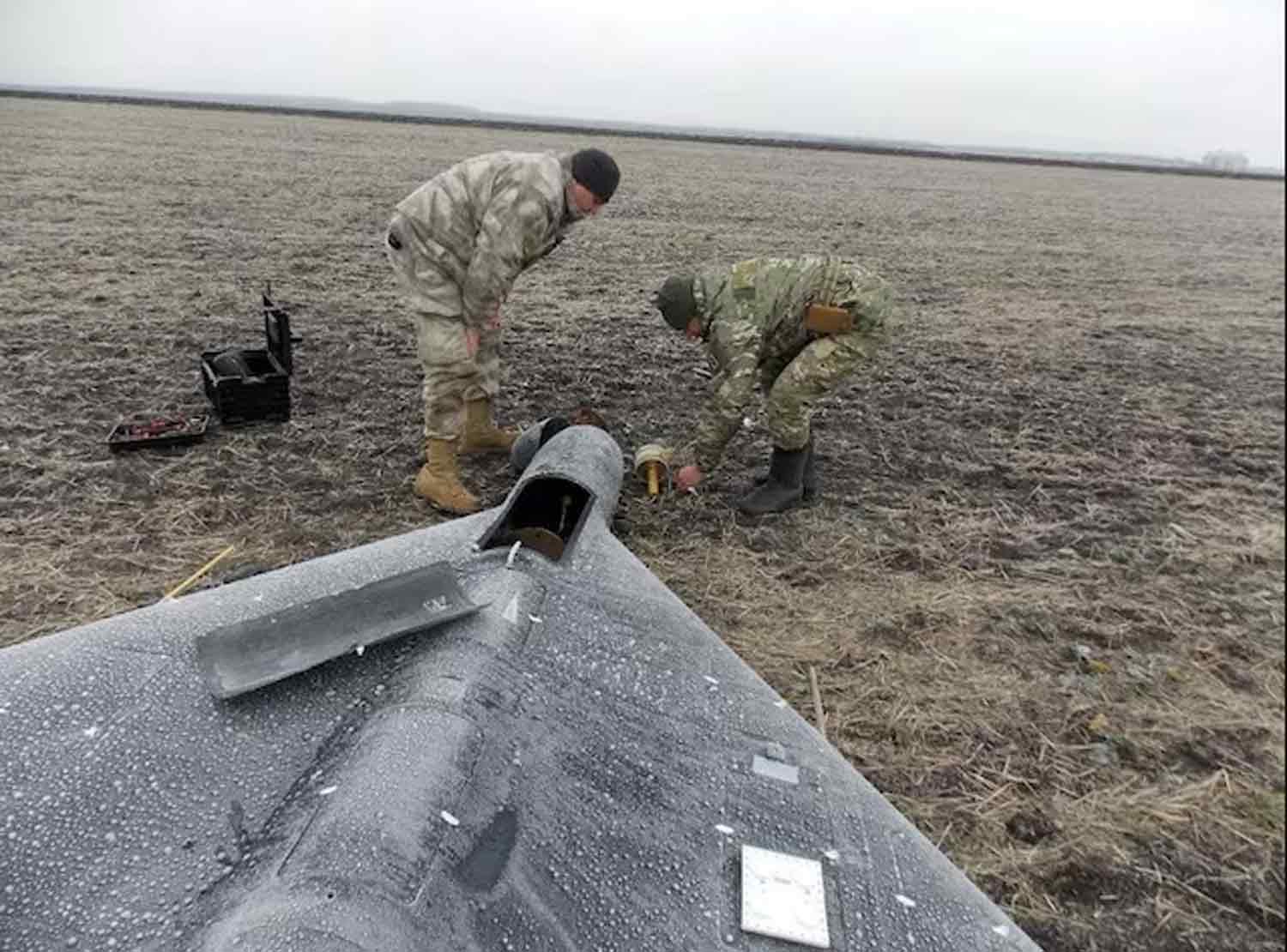 Members-of-police-demining-unit-remove-a-warhead-from-a-Russian-kamikaze-unmanned-aerial-vehicle-landed-by-a-radio-electronic-warfare-during-one-of-latest-drone-strikes,-amid-Russia's-attack-on-Ukraine