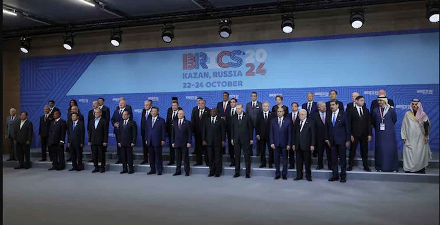 Russian President Vladimir Putin and participants in the outreach/BRICS Plus format meeting pose for a family photo during the BRICS summit in Kazan, Russia.