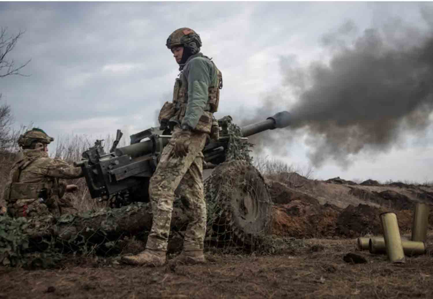 Ukrainian service members from a battalion, fire a howitzer M119 at a front line, amid Russia's attack on Ukraine, near the city of Bakhmut, Ukraine.