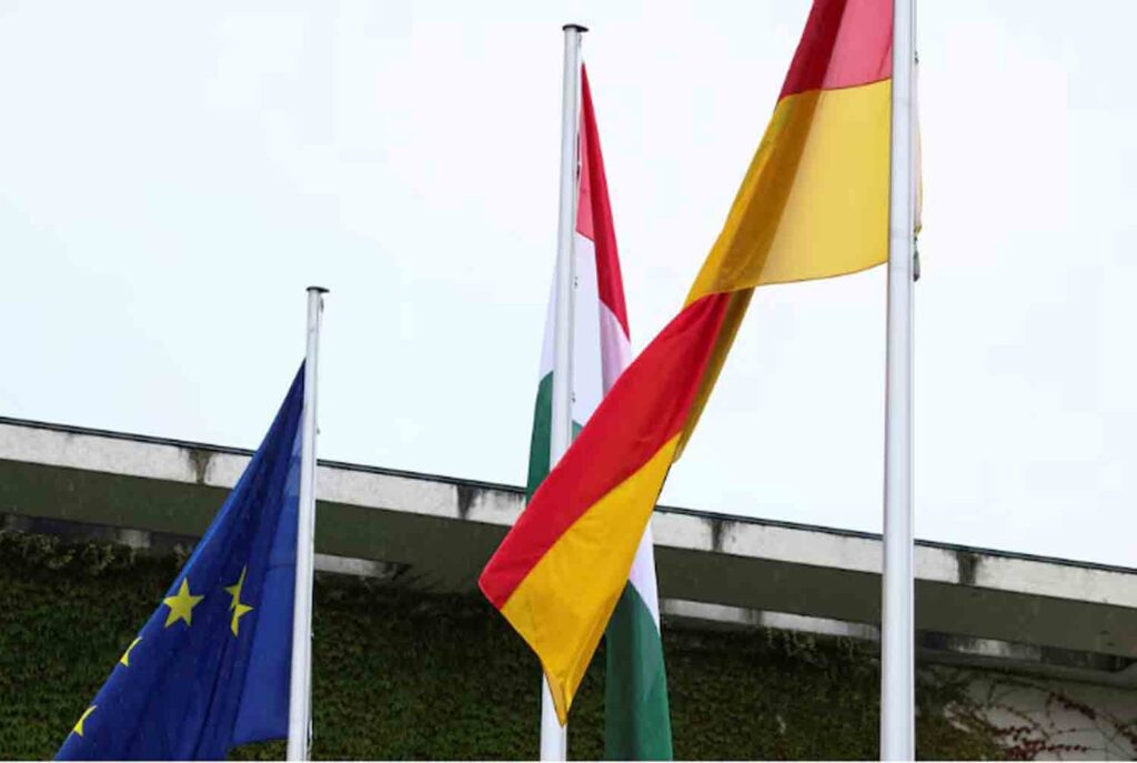 The flags of the European Union, Hungary and Germany fly outside Berlin's chancellery in Berlin, Germany