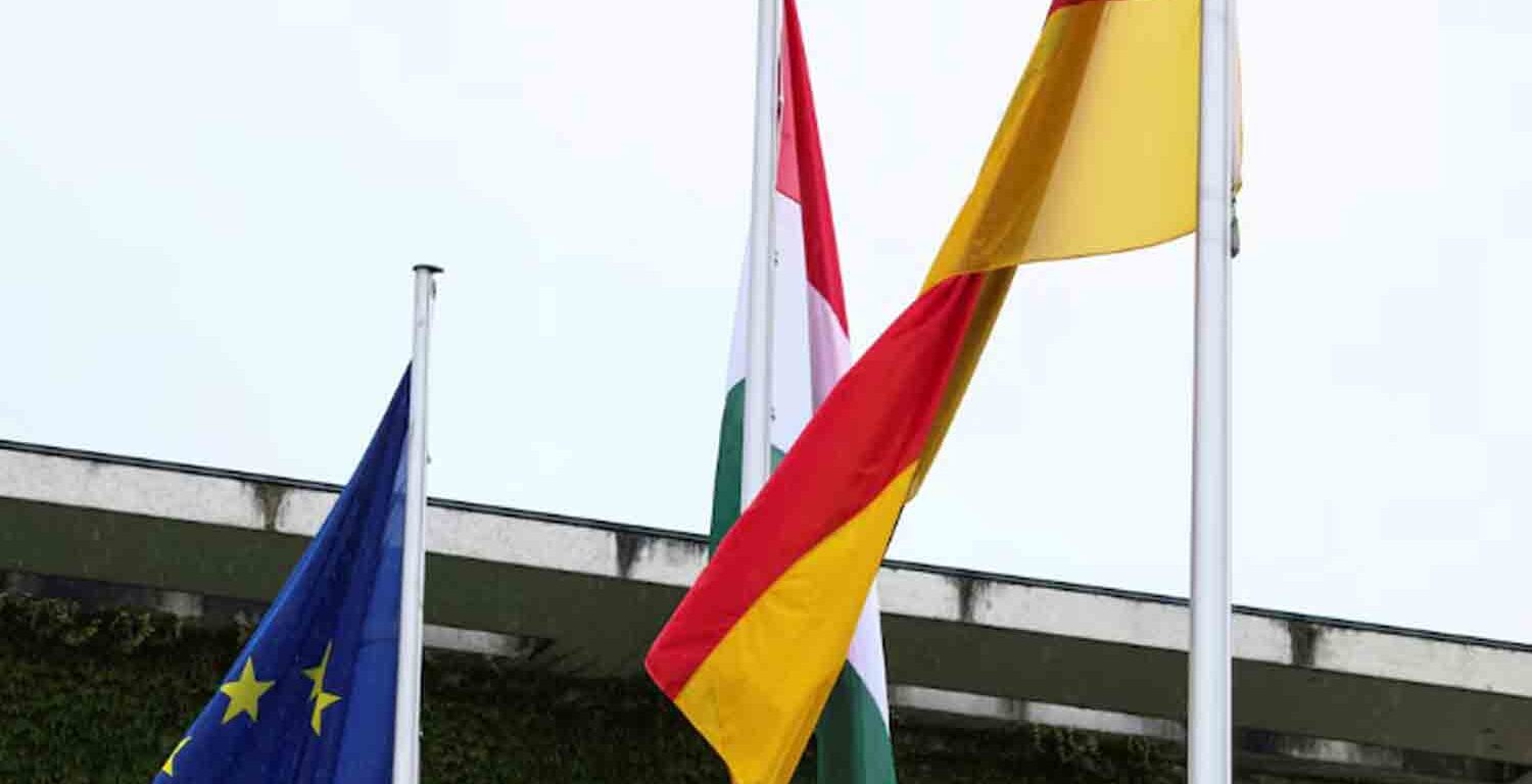 The flags of the European Union, Hungary and Germany fly outside Berlin's chancellery in Berlin, Germany