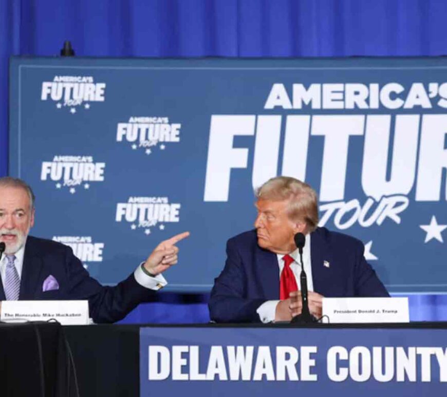 Mike Huckabee speaks as Republican presidential nominee and former U.S. President Donald Trump looks at him during a campaign event at the Drexelbrook Catering and Event Center, in Drexel Hill, Pennsylvania, U.S.