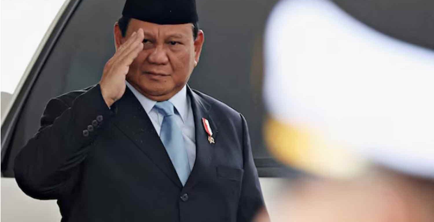 Indonesian President Prabowo Subianto gestures as he attends the annual State of the Nation Address at the parliament building