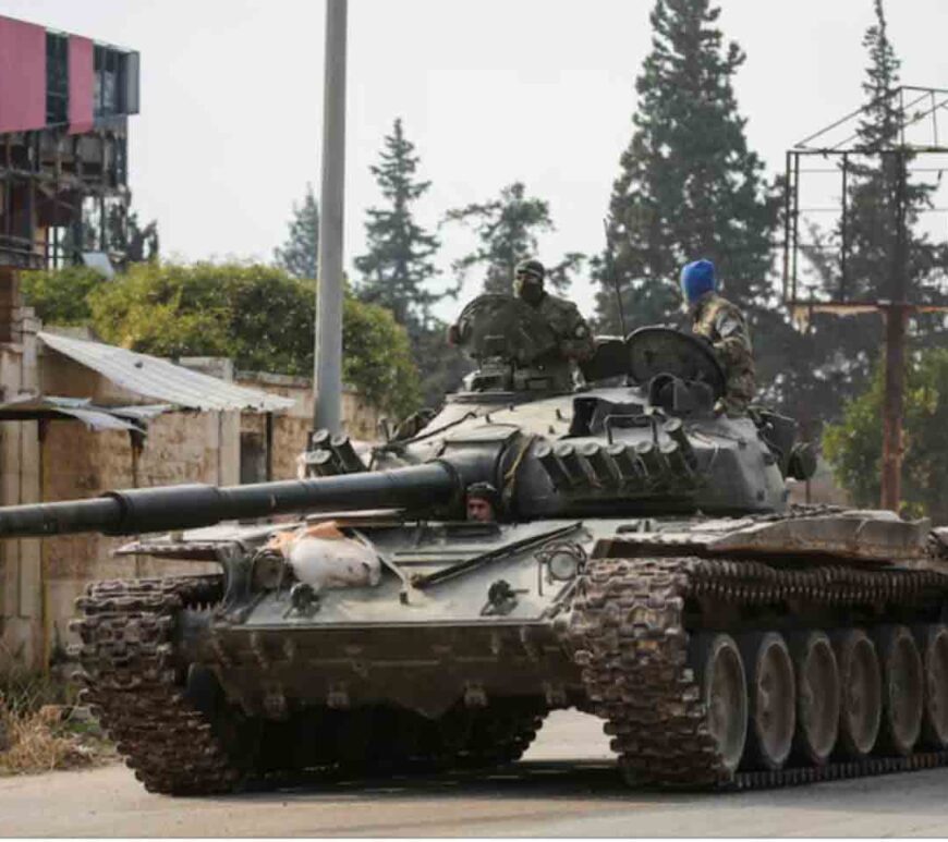 Rebels led by the Islamist militant group Hayat Tahrir al-Sham drive a military vehicle in al-Rashideen, Aleppo province, Syria.