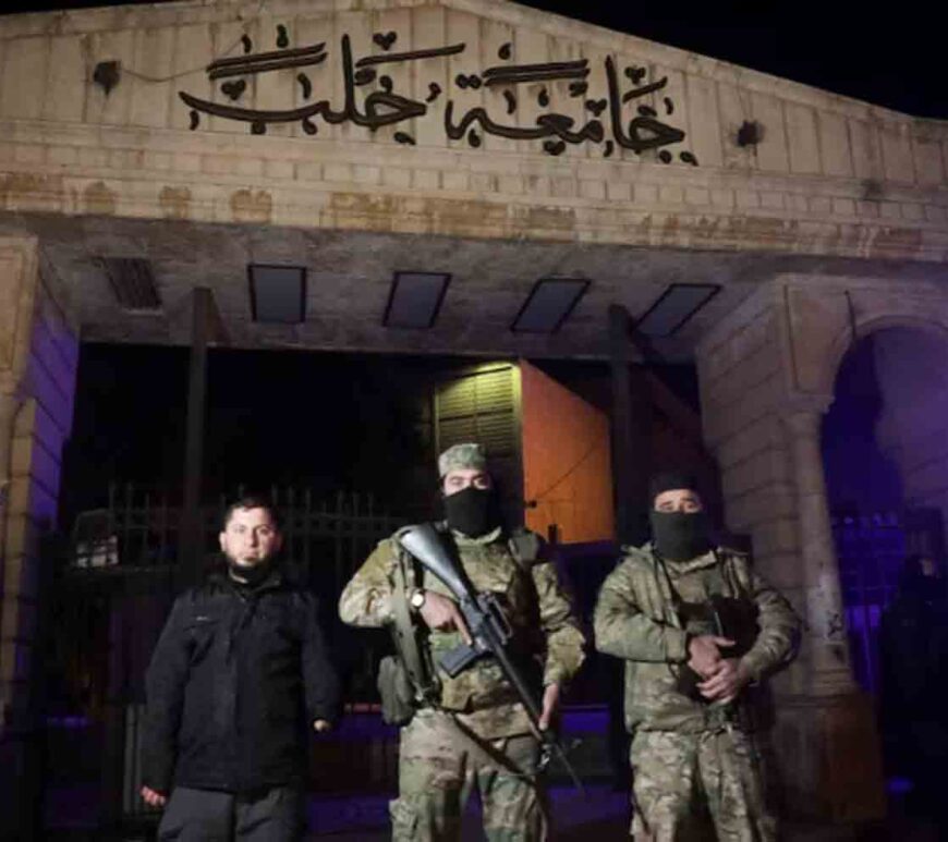 Syrian opposition fighters stand in front of University of Aleppo, after rebels opposed to Syria's President Bashar al-Assad said they had reached the heart of Aleppo, Syria.