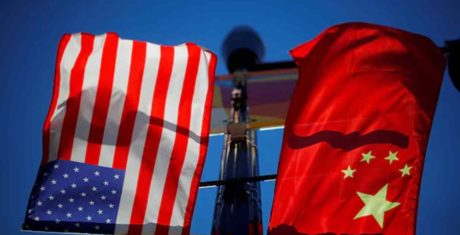 The flags of the United States and China fly from a lamppost in the Chinatown neighborhood of Boston, Massachusetts, U.S.