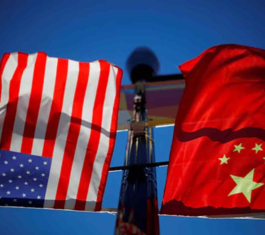 The flags of the United States and China fly from a lamppost in the Chinatown neighborhood of Boston, Massachusetts, U.S.