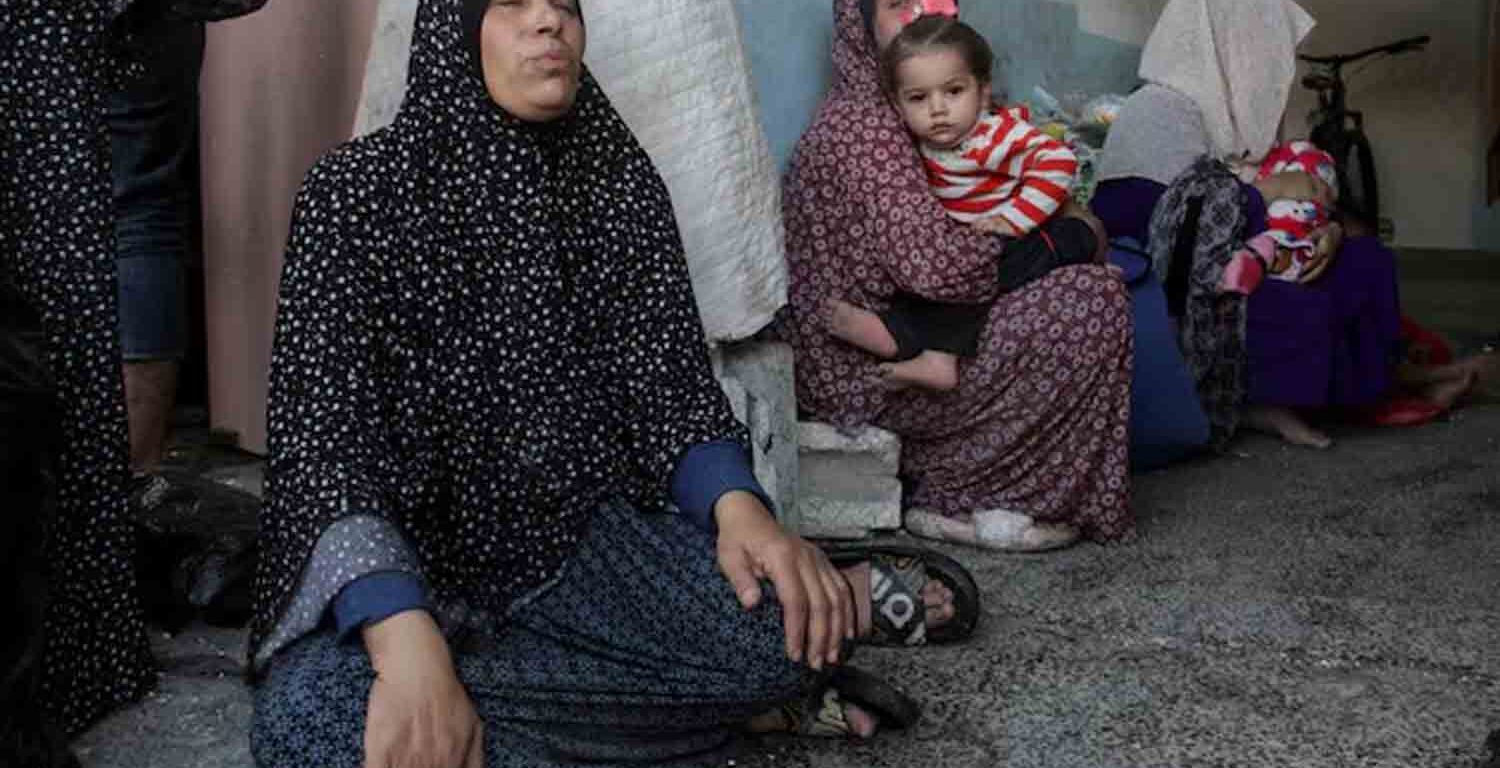 Palestinians react after a school sheltering displaced people was hit by an Israeli strike, at Beach camp in Gaza City .