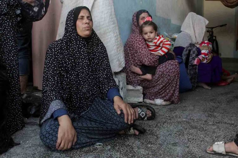 Palestinians react after a school sheltering displaced people was hit by an Israeli strike, at Beach camp in Gaza City .
