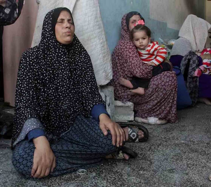 Palestinians react after a school sheltering displaced people was hit by an Israeli strike, at Beach camp in Gaza City .