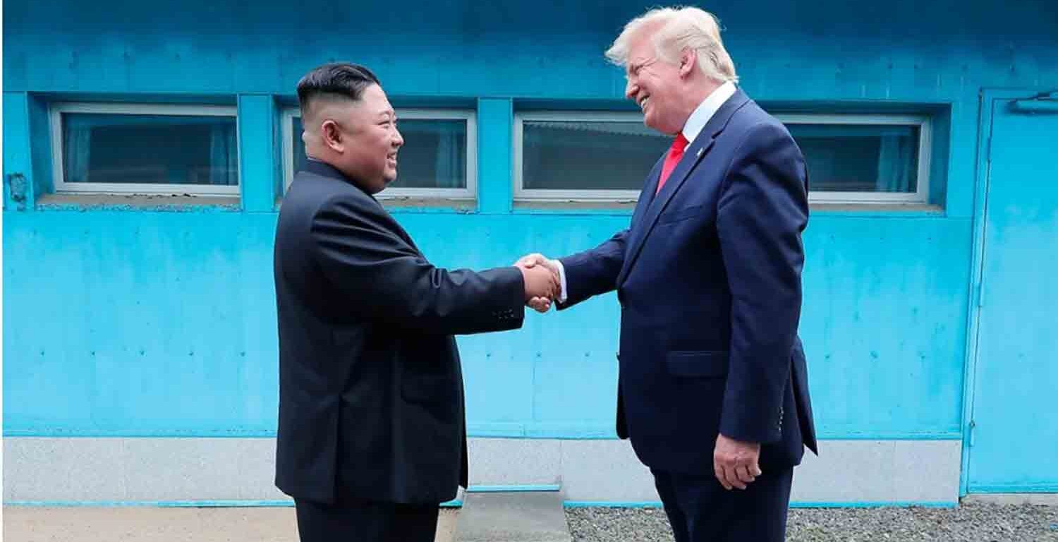 North Korean leader Kim Jong Un and U.S. then-President Donald Trump shake hands over the military demarcation line between North and South Korea on June 30, 2019.