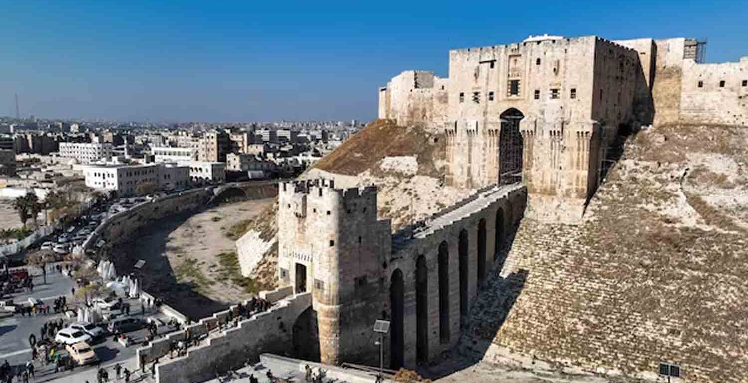 People walk at Aleppo's ancient citadel in this picture from a drone, in Aleppo, Syria.