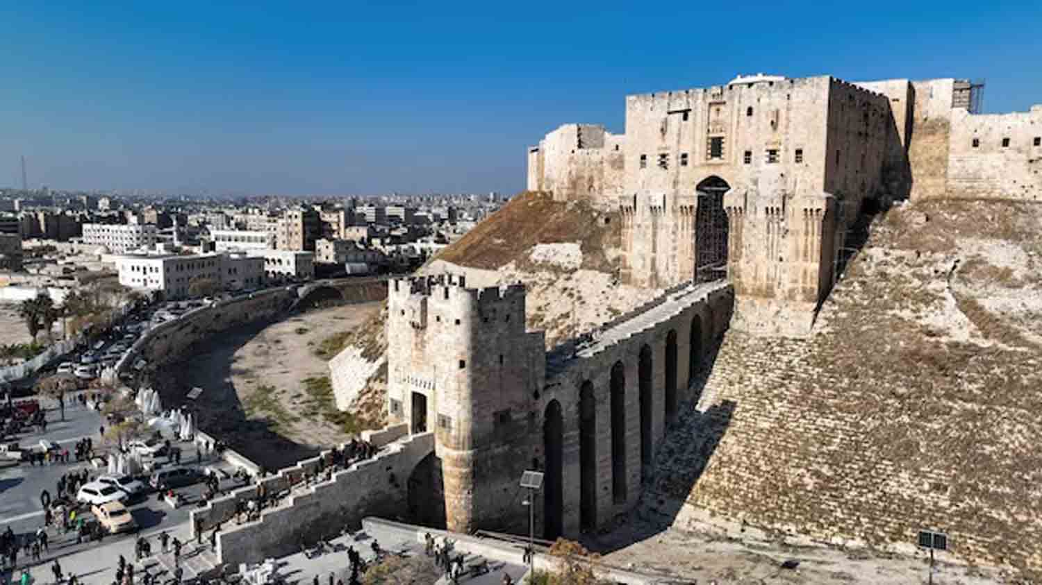 People walk at Aleppo's ancient citadel in this picture from a drone, in Aleppo, Syria.