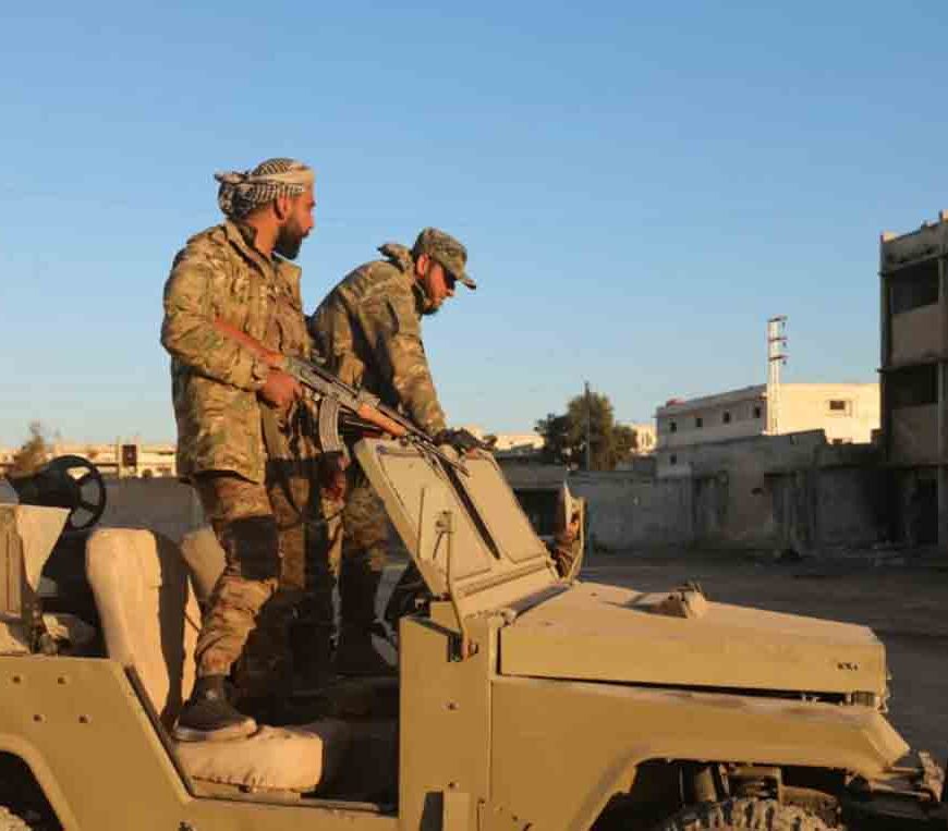 Anti-government fighters inspect a base belonging to the Iran-backed Fatemiyoun Brigade in the town of Khan Sheikhun, in the northwestern Syrian Idlib province.