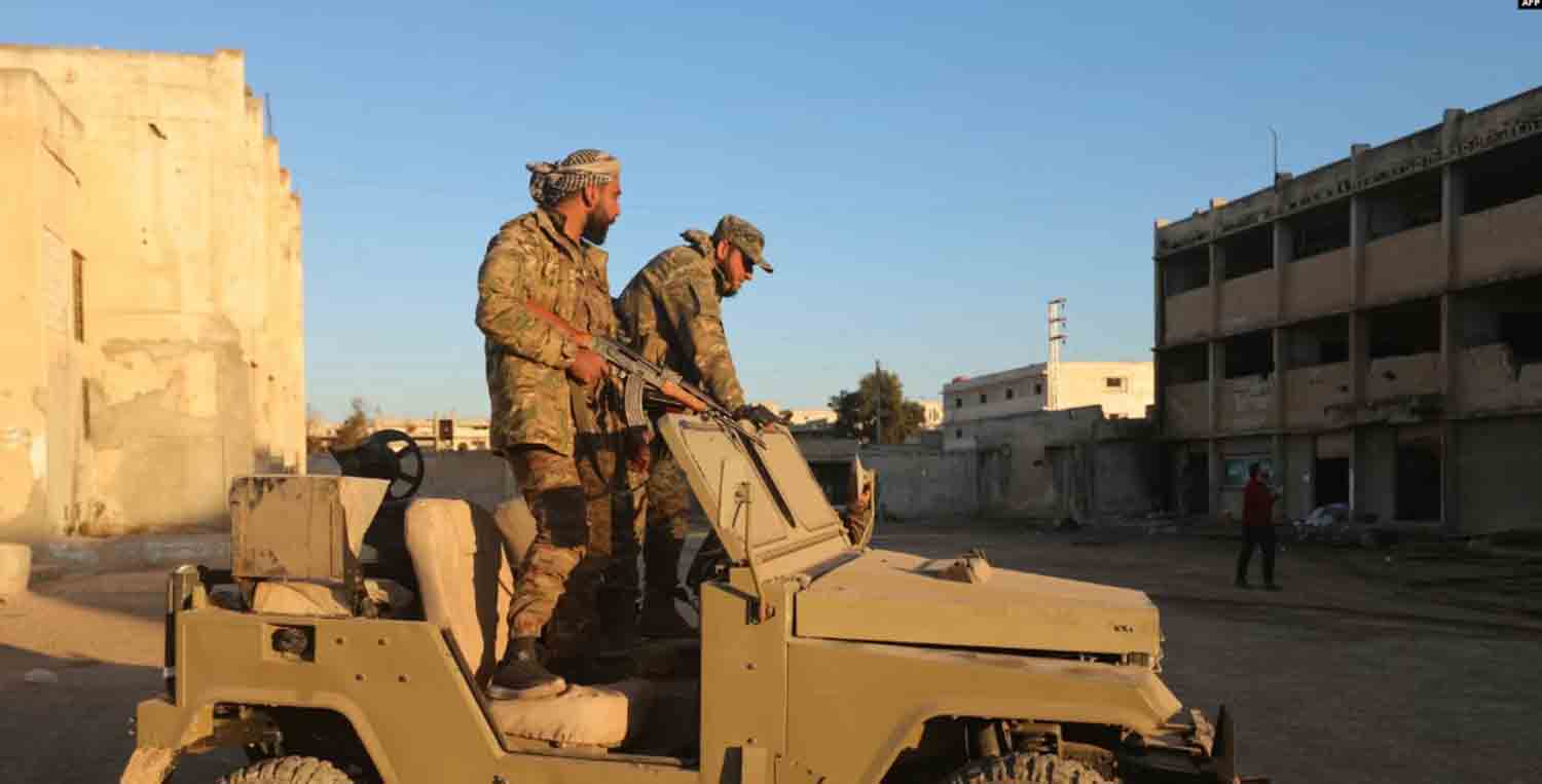 Anti-government fighters inspect a base belonging to the Iran-backed Fatemiyoun Brigade in the town of Khan Sheikhun, in the northwestern Syrian Idlib province.