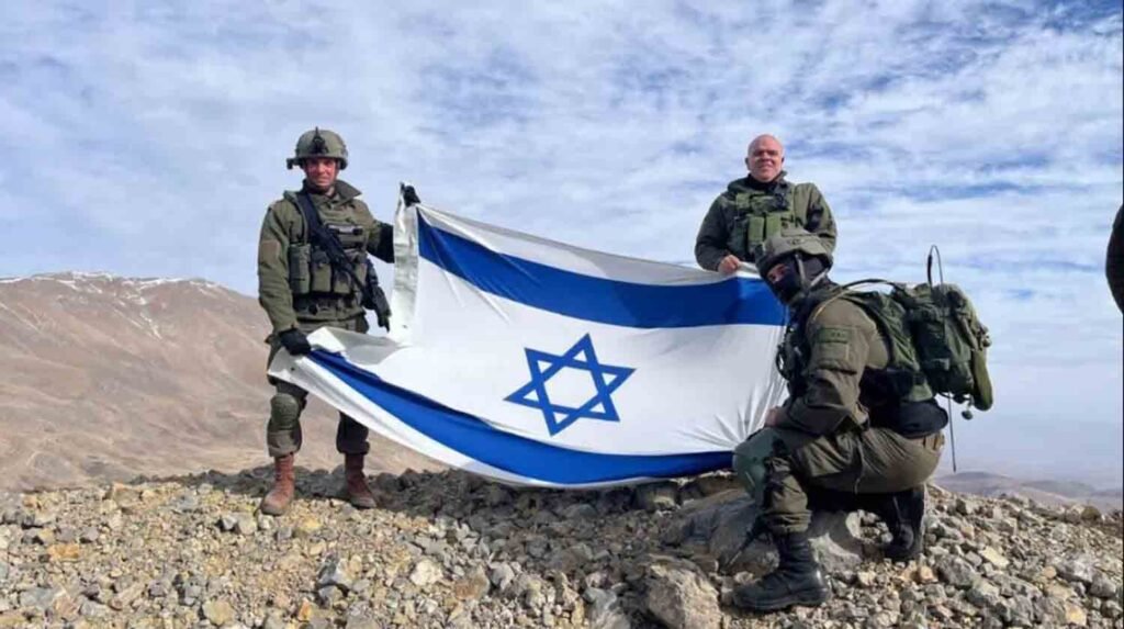 Israeli soldiers stand on Mount Hermon, in Syria.