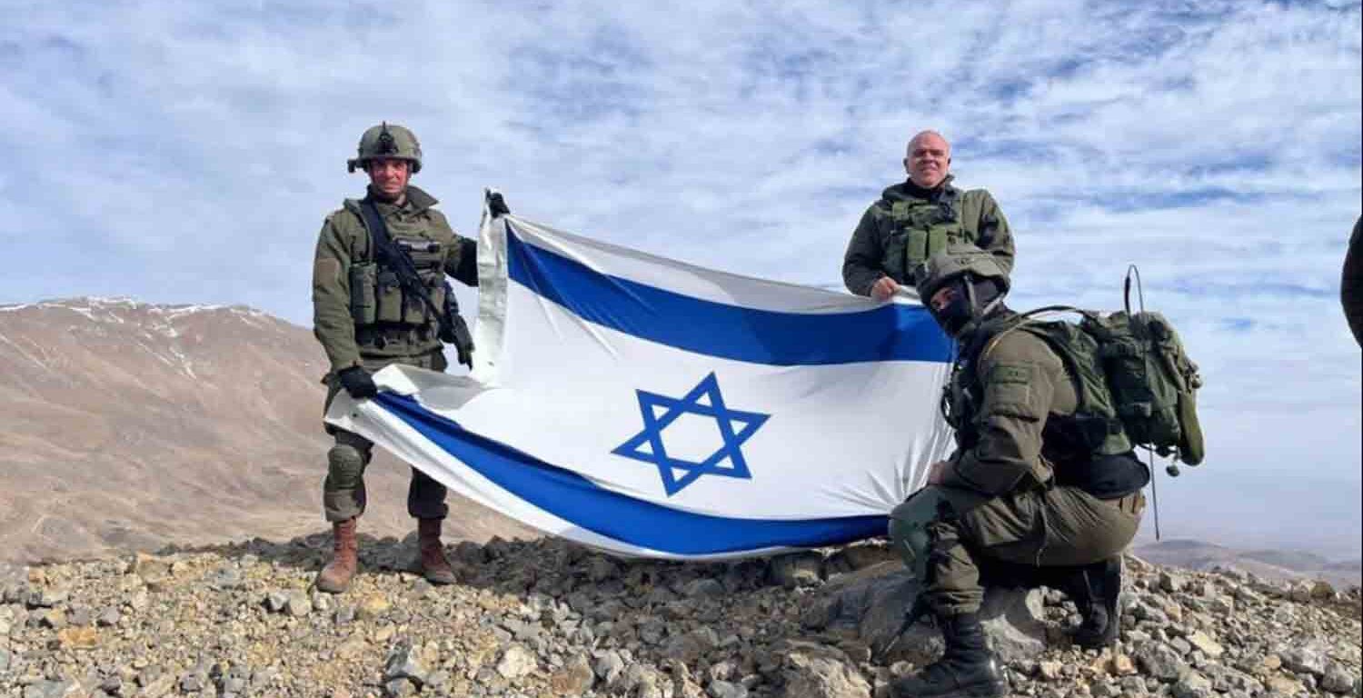 Israeli soldiers stand on Mount Hermon, in Syria.