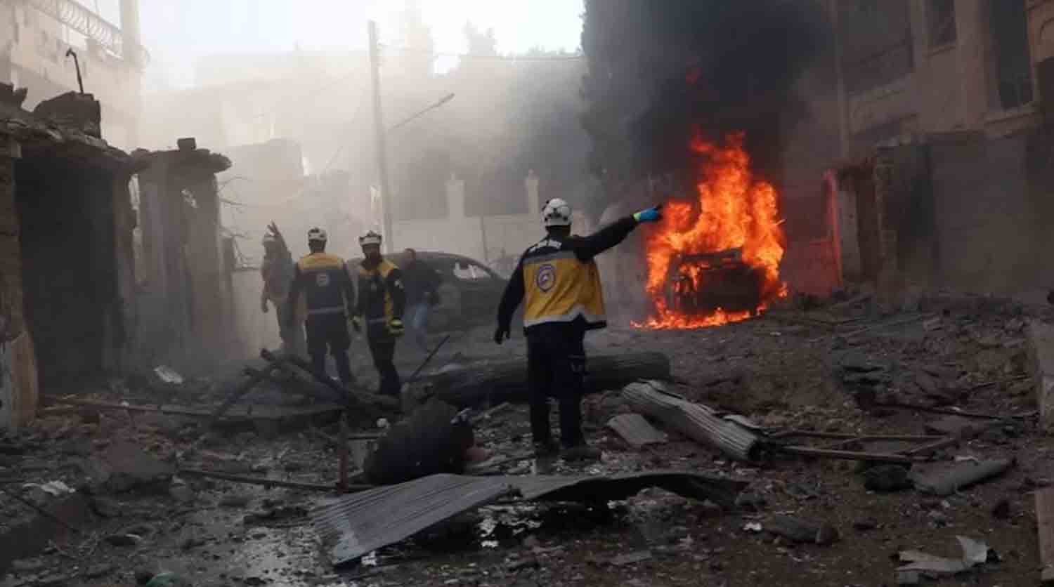 White Helmets members work at the scene of what the organisation says is a strike, in Idlib, Syria.