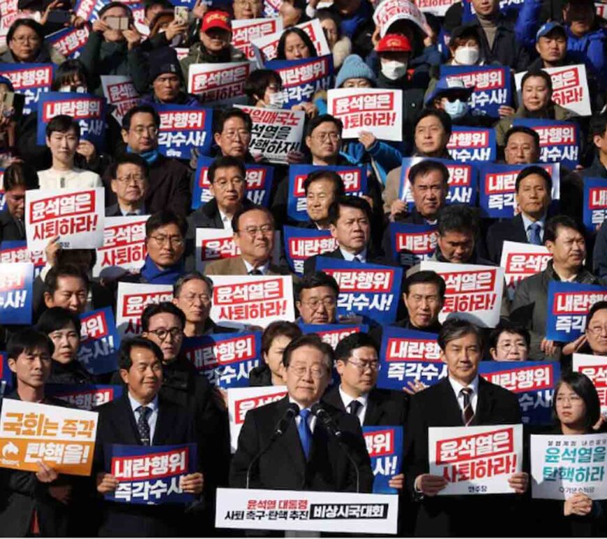 South Korea's main opposition Democratic Party leader Lee Jae-myung looks on as people hold placards that read "Step down President Yoon Suk Yeol" and "Investigate his act of rebellion immediately", at a rally to condemn South Korean President's surprise declarations of the martial law last night and to call for his resignation, at the national assembly in Seoul, South Korea.