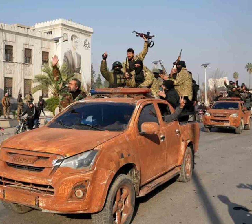 Syrian anti-government fighters celebrate as they pour into the captured central-west city of Hama.