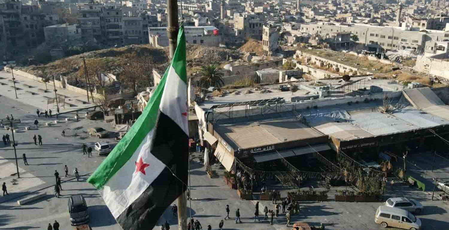 A Syrian opposition flag flies above a market square in central Aleppo.