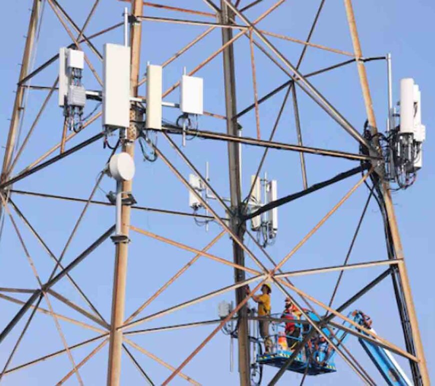 Technicians install 5G equipment on a utilities tower in Redondo Beach, California, U.S.,