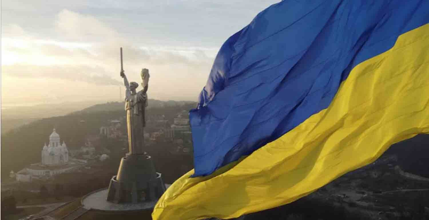 Ukraine's biggest national flag on the country's highest flagpole and the giant 'Motherland' monument are seen at a compound of the World War II museum in Kyiv, Ukraine.