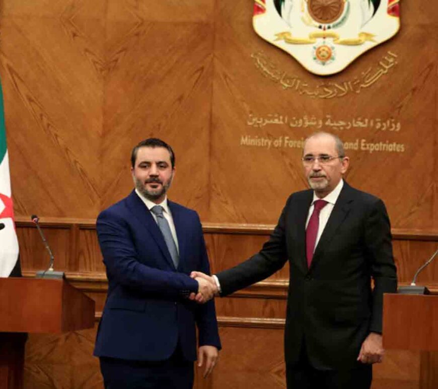 Syrian Foreign Minister Asaad Hassan al-Shibani and Jordanian Foreign Minister Ayman Safadi shake hands during a press conference as they meet in Amman, Jordan.