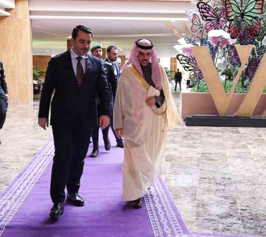 Syria's Foreign Minister Asaad Hassan al-Shibani walks with Saudi Foreign Minister Faisal bin Farhan Al Saud, as he arrives for a meeting on Syria, following the recent ousting of president Bashar al-Assad, in Riyadh, Saudi Arabia۔