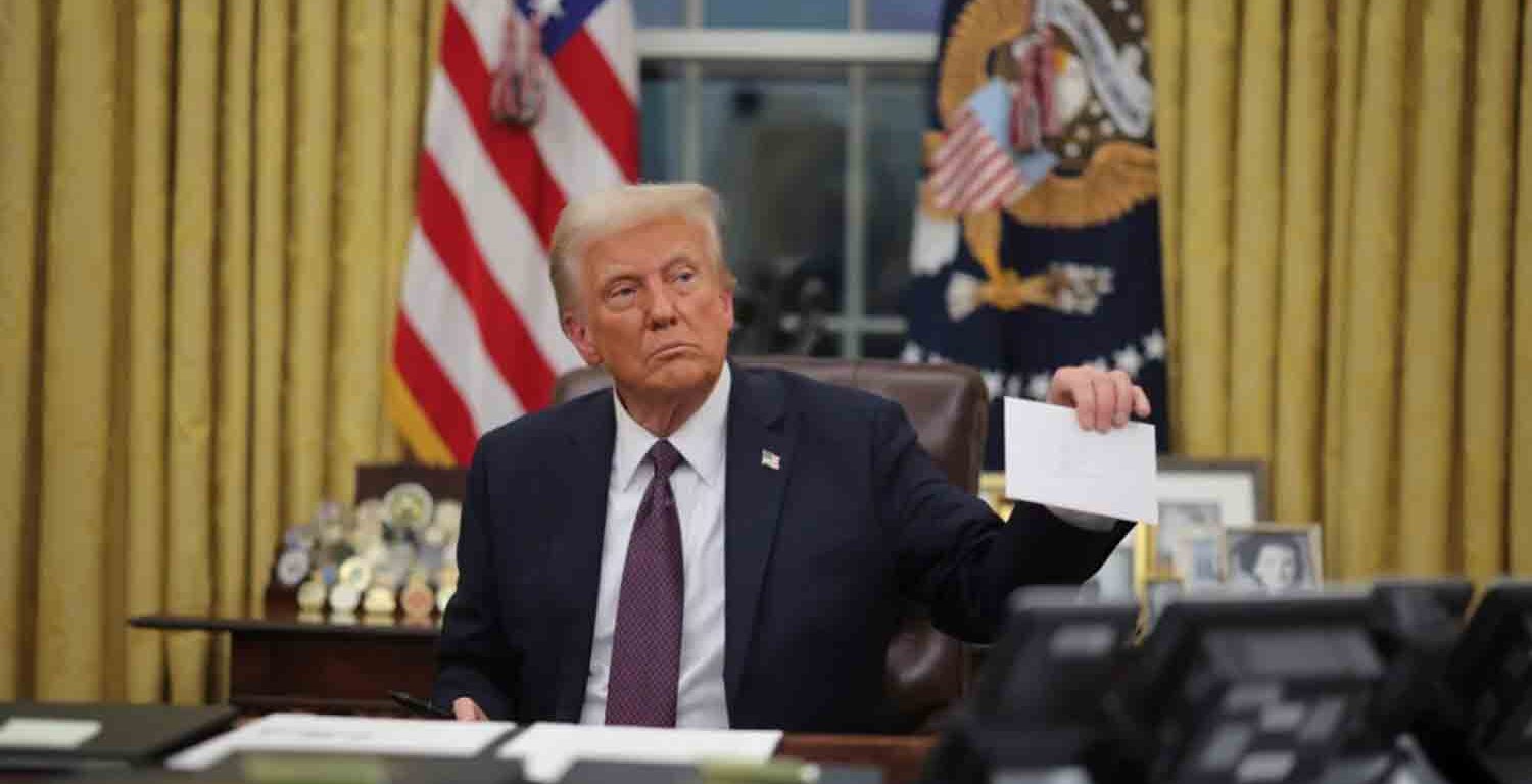 President Donald Trump holds a letter from former United States President Joe Biden in the Oval Office on Inauguration Day in Washington.