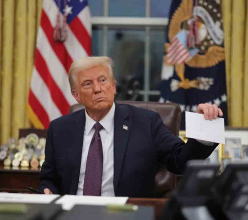 President Donald Trump holds a letter from former United States President Joe Biden in the Oval Office on Inauguration Day in Washington.