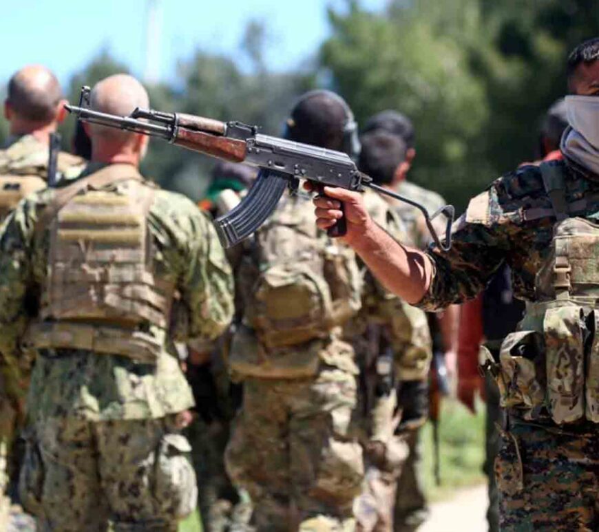 Fighters from the Kurdish People's Protection Units (YPG) stand guard at the site of Turkish airstrikes near northeastern Syrian Kurdish town of Derik, known as al-Malikiyah in Arabic.