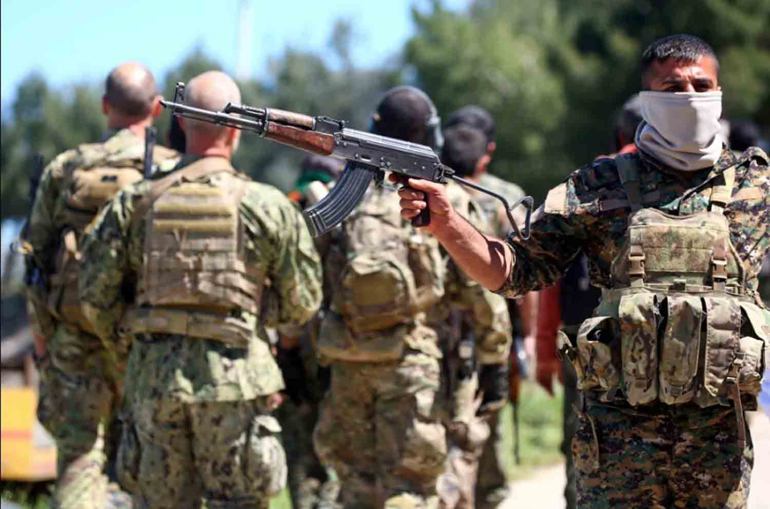 Fighters-from-the-Kurdish-People's-Protection-Units-YPG Fighters from the Kurdish People's Protection Units (YPG) stand guard at the site of Turkish airstrikes near northeastern Syrian Kurdish town of Derik, known as al-Malikiyah in Arabic.