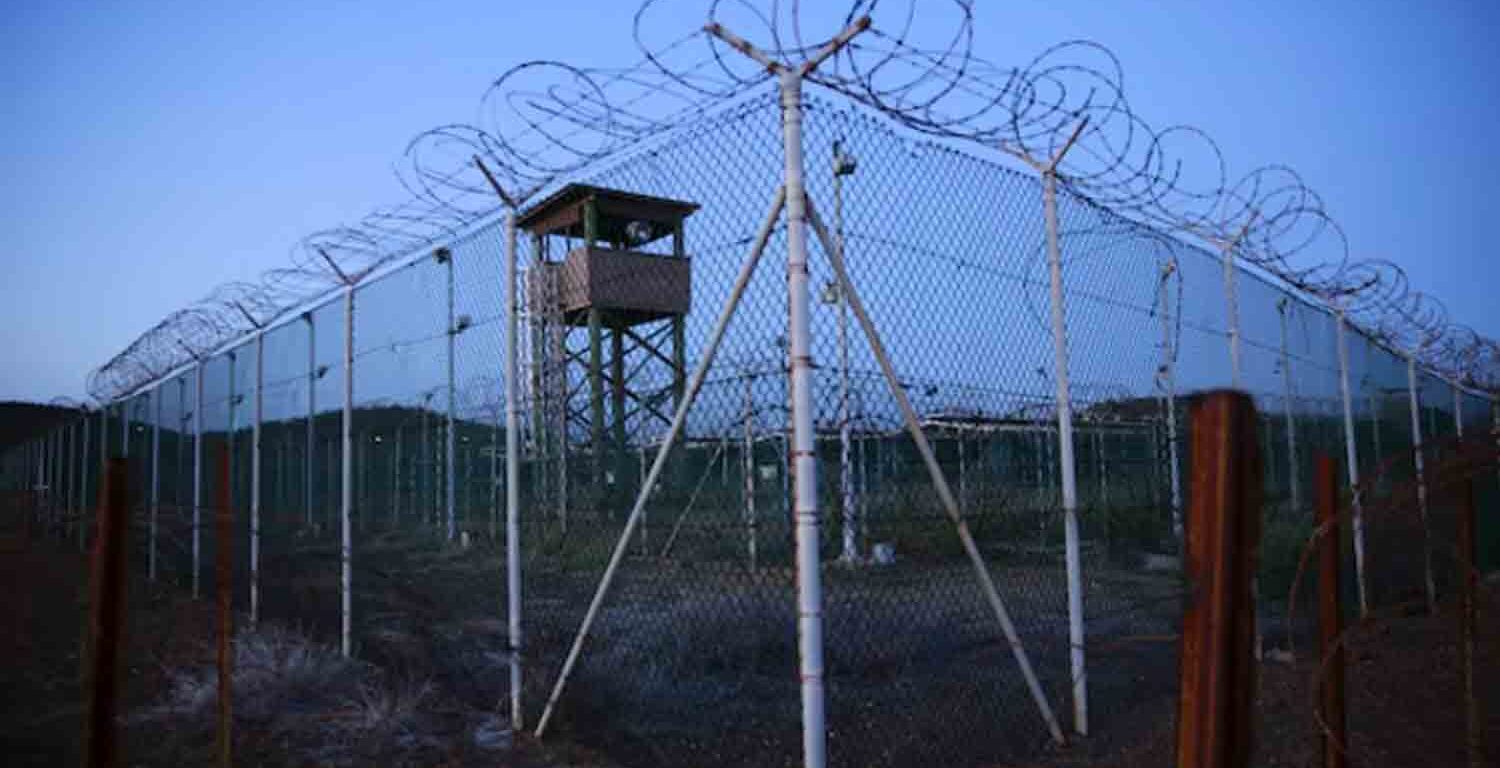 Chain link fence and concertina wire surrounds a deserted guard tower within Joint Task Force Guantanamo's Camp Delta at the U.S. Naval Base in Guantanamo Bay, Cuba.