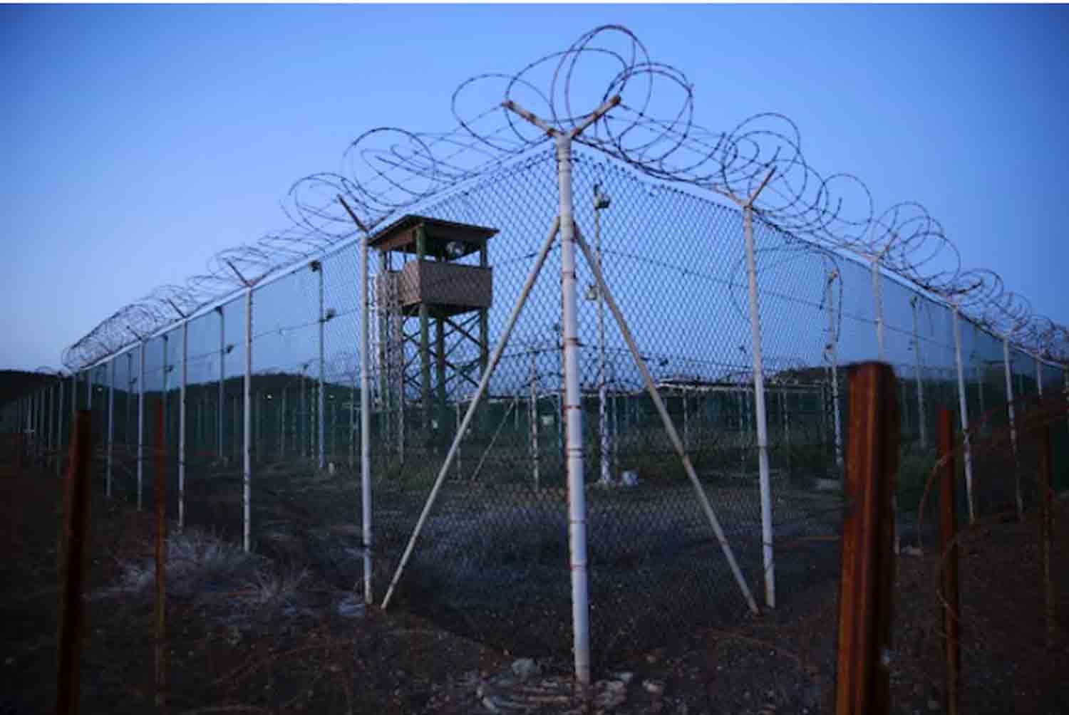 Chain link fence and concertina wire surrounds a deserted guard tower within Joint Task Force Guantanamo's Camp Delta at the U.S. Naval Base in Guantanamo Bay, Cuba.