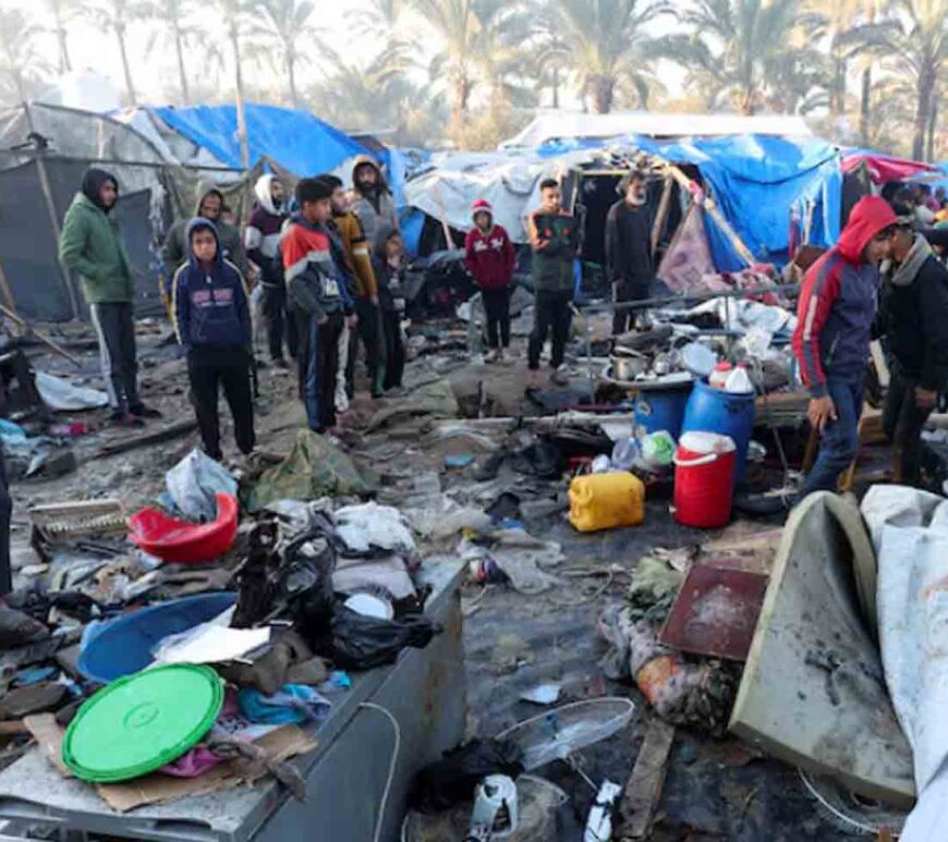 Palestinians inspect the site of an Israeli strike on a tent camp for displaced people, amid the ongoing conflict between Israel and Hamas, in Deir Al-Balah in the central Gaza Strip.