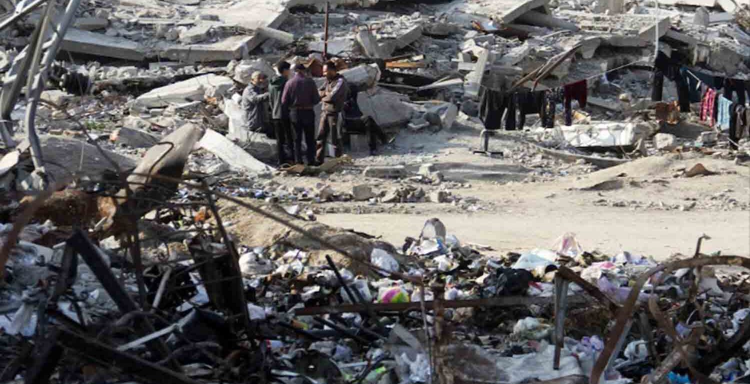 Palestinians stand among the rubble of houses destroyed in previous Israeli strikes, amid ceasefire negotiations with Israel, in Gaza City.