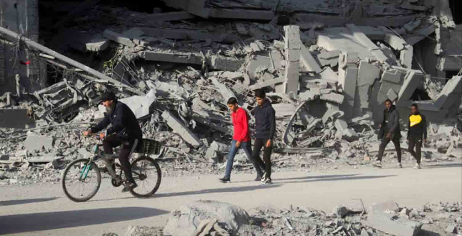 Palestinians walk among the rubble of houses destroyed in previous Israeli strikes, amid ceasefire negotiations with Israel, in Gaza City.