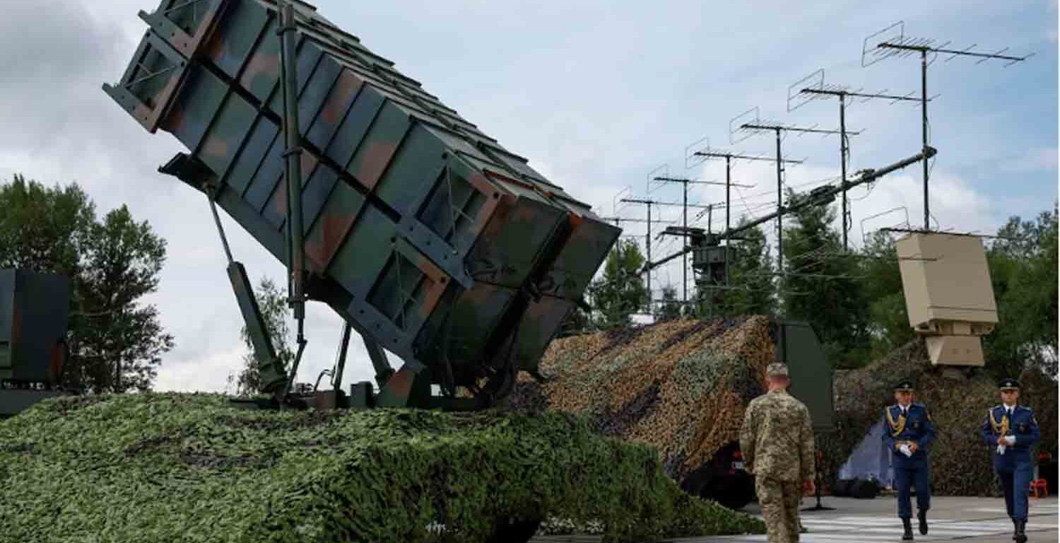 Ukrainian service members walk next to a launcher of a Patriot air defence system, amid Russia's attack on Ukraine, in an undisclosed location, Ukraine.