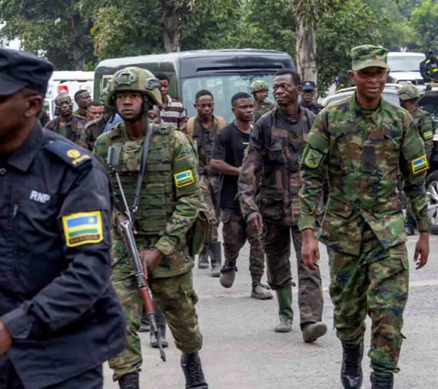 Rwandan security officers escort members of the Armed Forces of the Democratic Republic of the Congo (FARDC), who surrendered in Goma, eastern Democratic Republic of Congo, following fighting between M23 rebels and the FARDC, in Gisenyi, Rwanda.