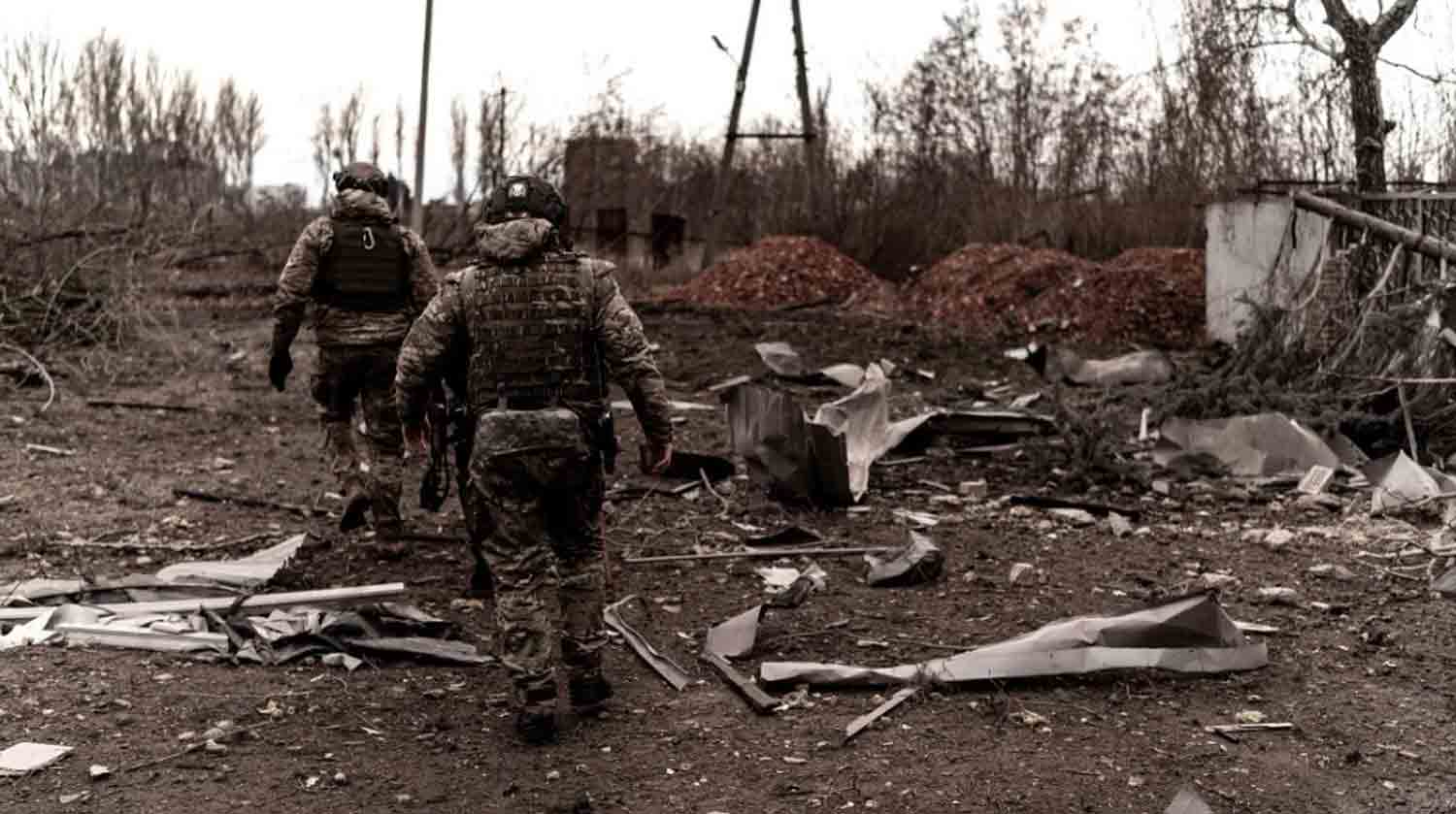 Soldiers walk among debris as civilians evacuate Pokrovsk in eastern Ukraine.