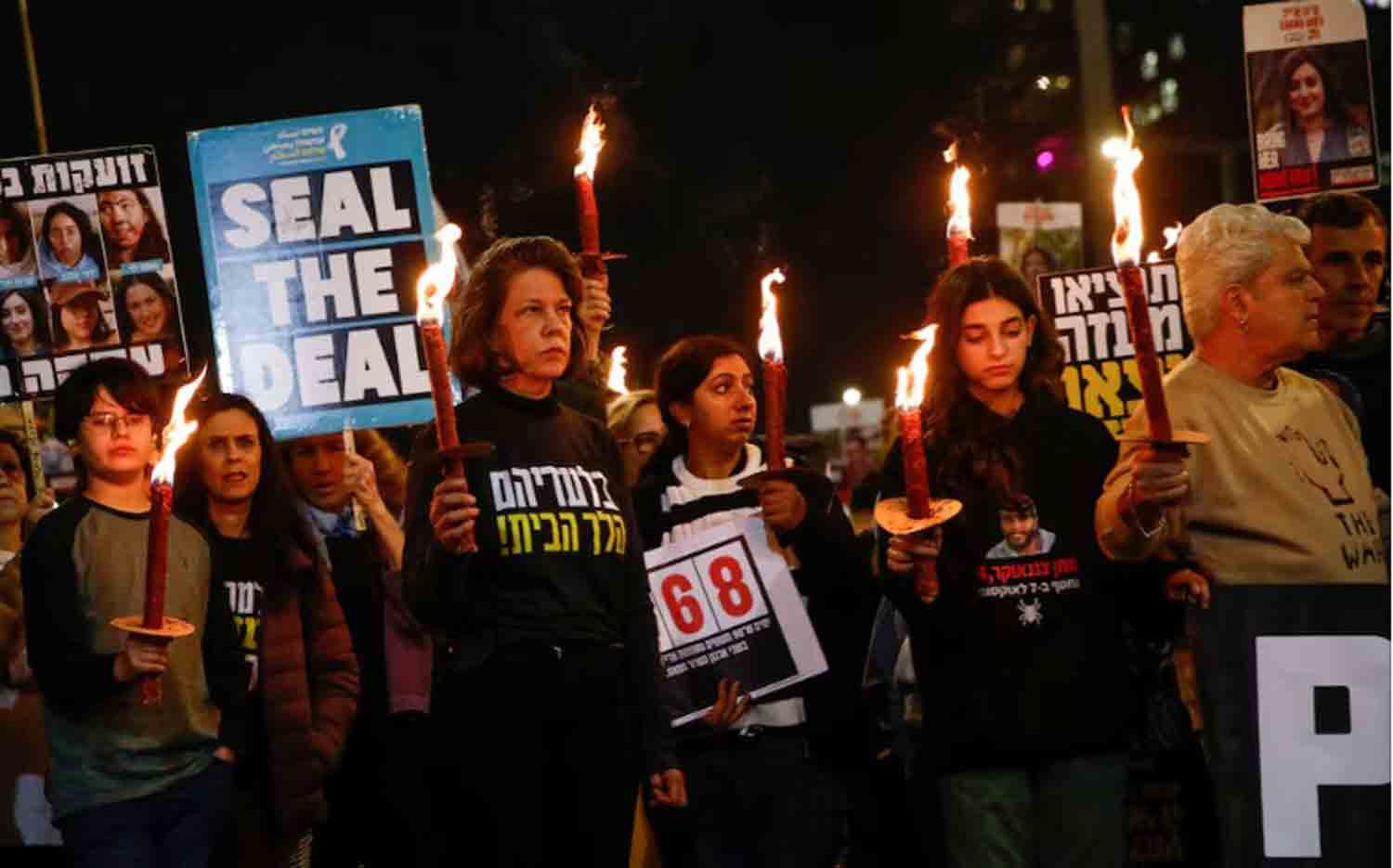 Supporters-and-family-members-of-hostages Supporters and family members of hostages kidnapped during the deadly October 7, 2023, attack on Israel by Hamas, hold lit torches during a protest ahead of a ceasefire between Israel and Hamas, in Tel Aviv, Israel.