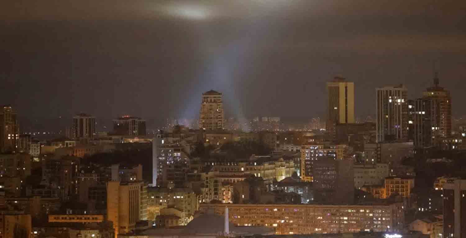 Ukrainian service personnel use searchlights as they search for drones in the sky over the city during a Russian drone strike, amid Russia's attack on Ukraine, in Kyiv, Ukraine.